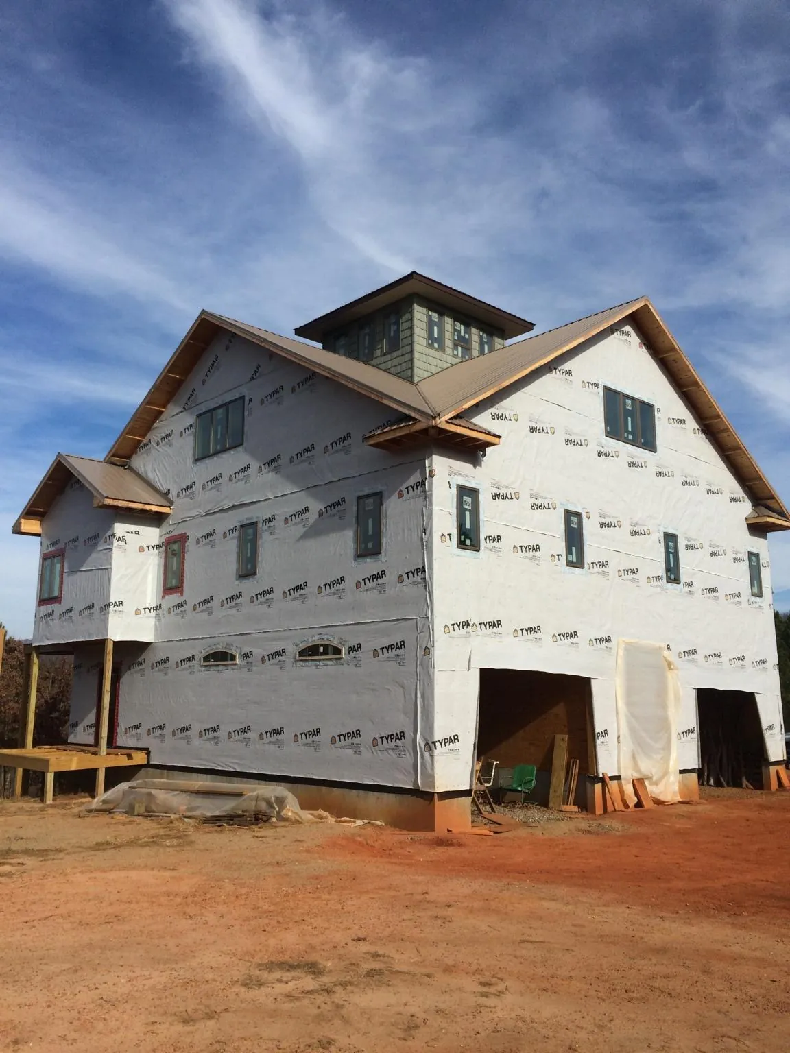 New two story house under construction with a cupola and gabled roofs in Dickinson
